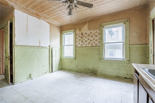 48 Rosedale St, Rochester, NY 14620 - kitchen featuring wainscoting, white cabinets, a ceiling fan, crown molding, and light countertops