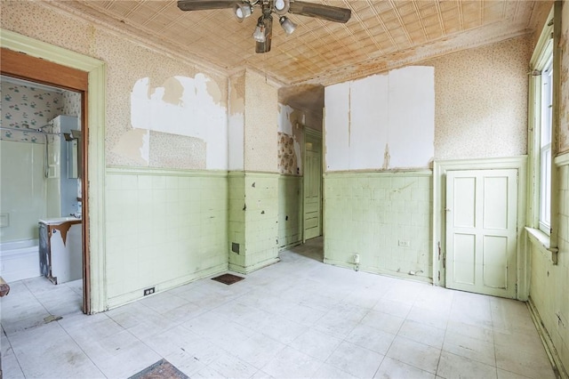 48 Rosedale St, Rochester, NY 14620 - unfurnished room featuring a ceiling fan, wallpapered walls, wainscoting, an ornate ceiling, and plenty of natural light