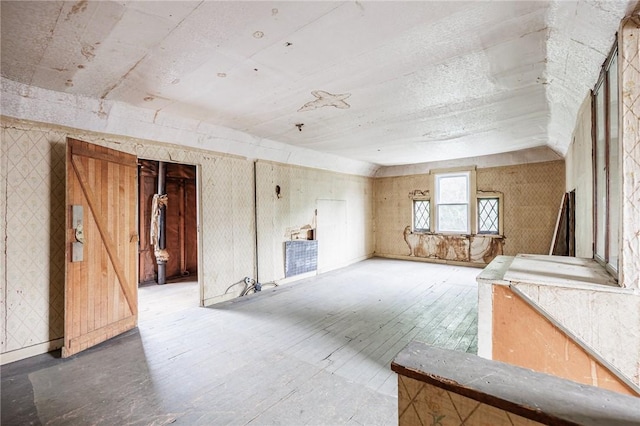 48 Rosedale St, Rochester, NY 14620 - unfurnished living room with wood-type flooring and wallpapered walls