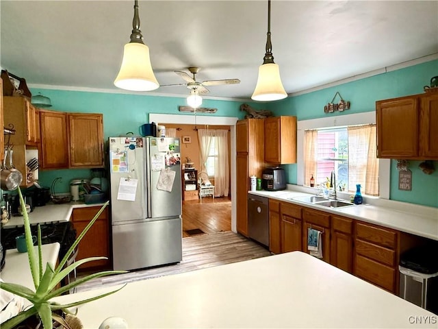 4935 N Jefferson St, Richland, NY 13142 - kitchen with stainless steel appliances, light countertops, brown cabinetry, and crown molding