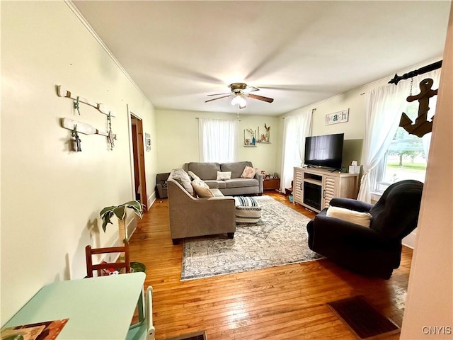 4935 N Jefferson St, Richland, NY 13142 - living area with light wood-style flooring, a ceiling fan, and crown molding