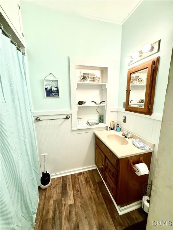 4935 N Jefferson St, Richland, NY 13142 - full bath with vanity, wood finished floors, curtained shower, and crown molding