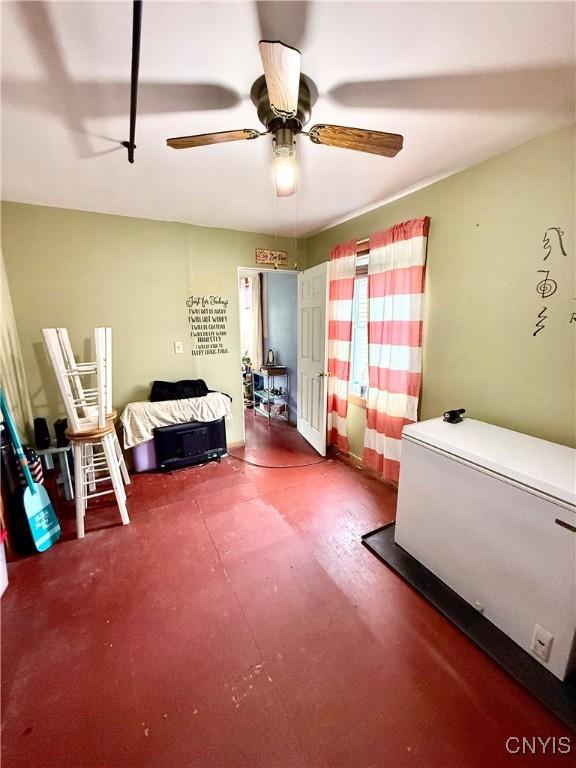 4935 N Jefferson St, Richland, NY 13142 - bedroom with ceiling fan and refrigerator