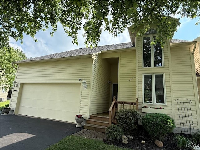 5326 Bunker Hill Way, Onondaga, NY 13207 - view of front facade featuring asphalt driveway, a garage, and roof with shingles
