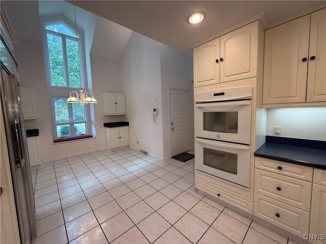 5326 Bunker Hill Way, Onondaga, NY 13207 - kitchen with double oven, plenty of natural light, light tile patterned flooring, vaulted ceiling, and dark countertops