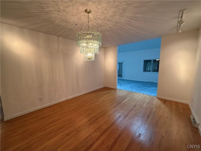 5326 Bunker Hill Way, Onondaga, NY 13207 - empty room with a chandelier and wood finished floors