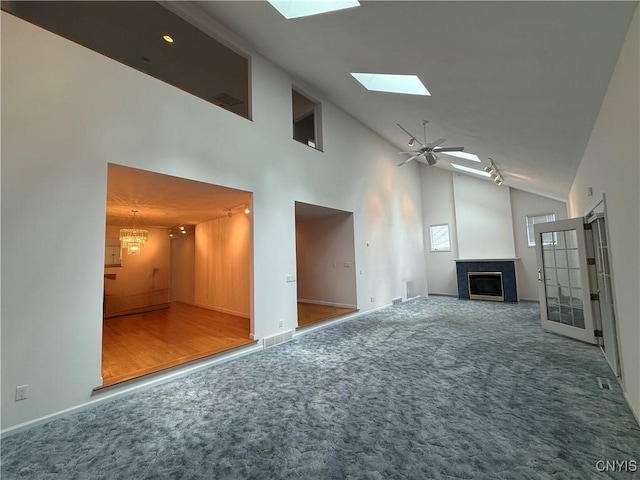 5326 Bunker Hill Way, Onondaga, NY 13207 - unfurnished living room featuring a skylight, carpet floors, a fireplace, high vaulted ceiling, and a ceiling fan