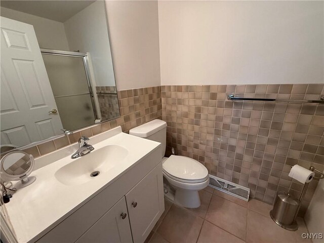 5326 Bunker Hill Way, Onondaga, NY 13207 - full bath featuring tile walls, a shower with shower door, vanity, wainscoting, and tile patterned flooring