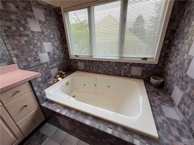 5326 Bunker Hill Way, Onondaga, NY 13207 - full bathroom with tile patterned flooring, a whirlpool tub, tile walls, and vanity
