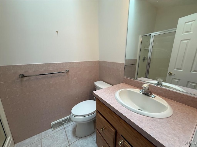 5326 Bunker Hill Way, Onondaga, NY 13207 - bathroom featuring a shower stall, tile patterned floors, vanity, tile walls, and a wainscoted wall