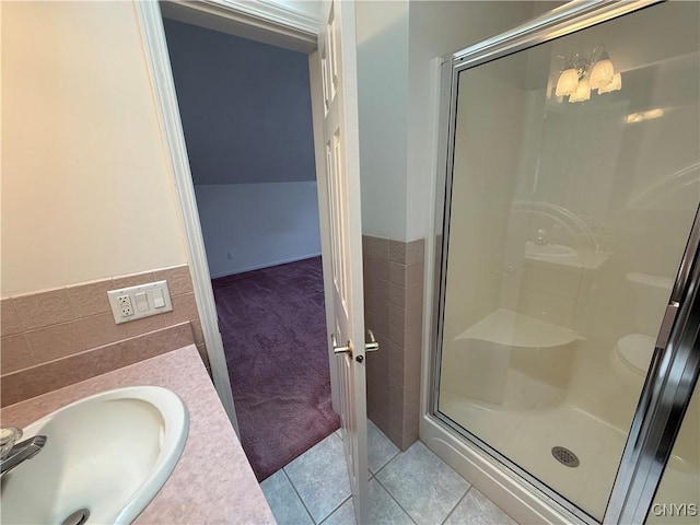 5326 Bunker Hill Way, Onondaga, NY 13207 - bathroom featuring a stall shower, tile walls, vanity, tile patterned flooring, and a wainscoted wall