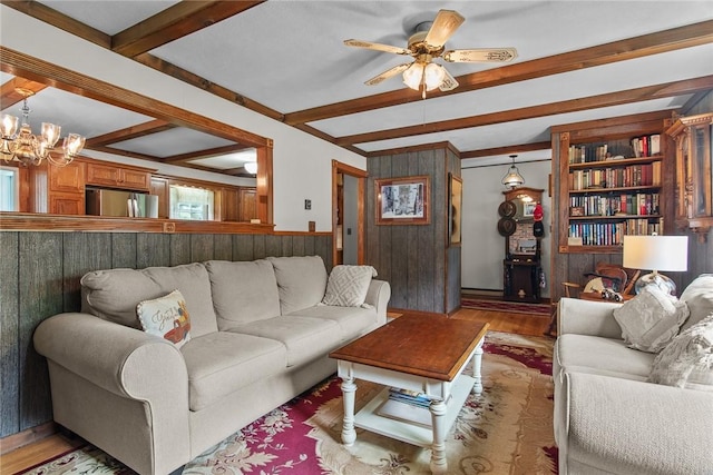 226 Academy St, Middletown, NY 12455 - living area featuring beam ceiling, wood finished floors, wooden walls, ceiling fan, and a chandelier