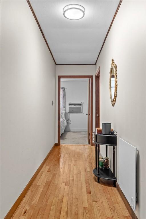 226 Academy St, Middletown, NY 12455 - corridor featuring light wood-type flooring, crown molding, and an AC wall unit