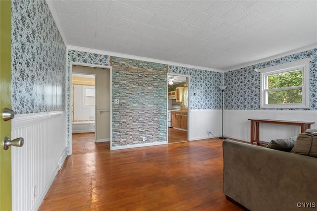 107 Edgeware Rd, Salina, NY 13208 - living area featuring wood finished floors, a wainscoted wall, crown molding, and wallpapered walls