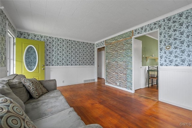 107 Edgeware Rd, Salina, NY 13208 - living area featuring wood finished floors, a wainscoted wall, wallpapered walls, and crown molding