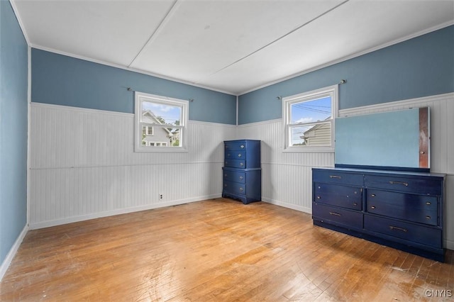 107 Edgeware Rd, Salina, NY 13208 - unfurnished bedroom featuring light wood-style flooring, wainscoting, and multiple windows