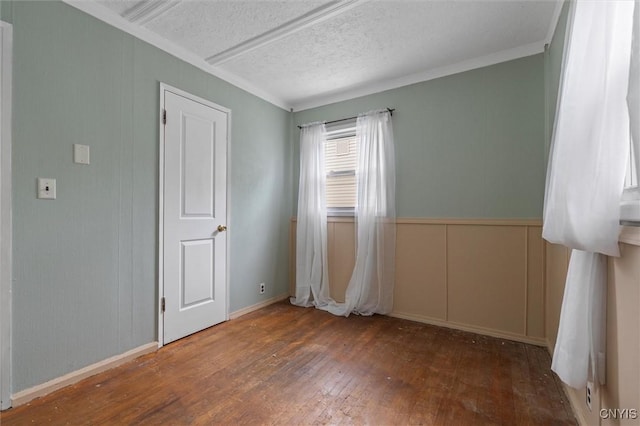 107 Edgeware Rd, Salina, NY 13208 - empty room with a decorative wall, wood-type flooring, a textured ceiling, and crown molding
