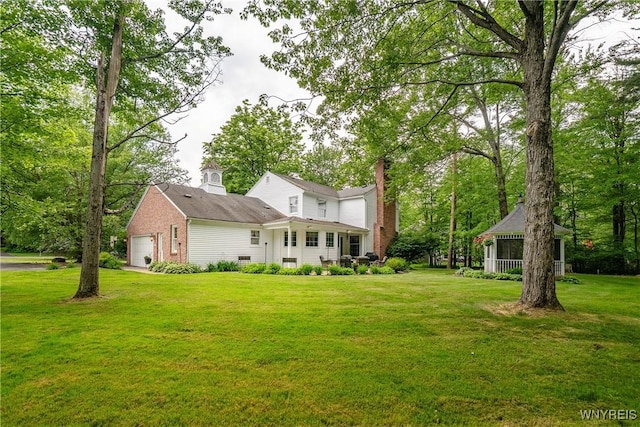 10 Knob Hill Rd, Orchard Park, NY 14127 - rear view of house with a yard, a chimney, and an attached garage