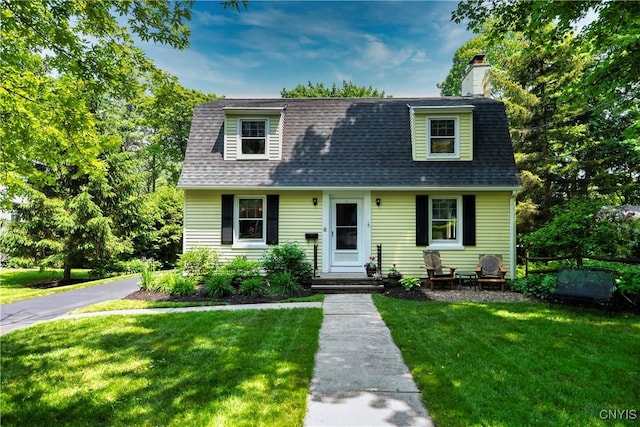 6 Orchard Rd, Skaneateles, NY 13152 - view of front of house featuring a front lawn, a chimney, and a shingled roof