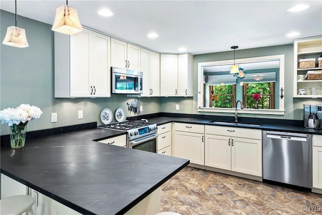 6 Orchard Rd, Skaneateles, NY 13152 - kitchen with stainless steel appliances, a peninsula, dark countertops, recessed lighting, and decorative light fixtures