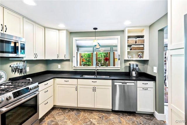 6 Orchard Rd, Skaneateles, NY 13152 - kitchen featuring appliances with stainless steel finishes, dark countertops, white cabinets, pendant lighting, and dark stone finish flooring