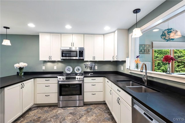 6 Orchard Rd, Skaneateles, NY 13152 - kitchen featuring stainless steel appliances, dark countertops, pendant lighting, recessed lighting, and white cabinetry