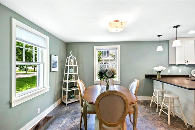 6 Orchard Rd, Skaneateles, NY 13152 - dining space featuring healthy amount of natural light and dark stone finish floors