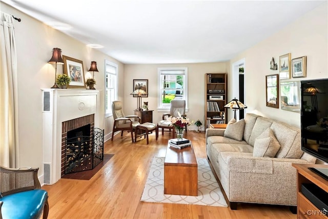 6 Orchard Rd, Skaneateles, NY 13152 - living area featuring a brick fireplace and light wood-style floors