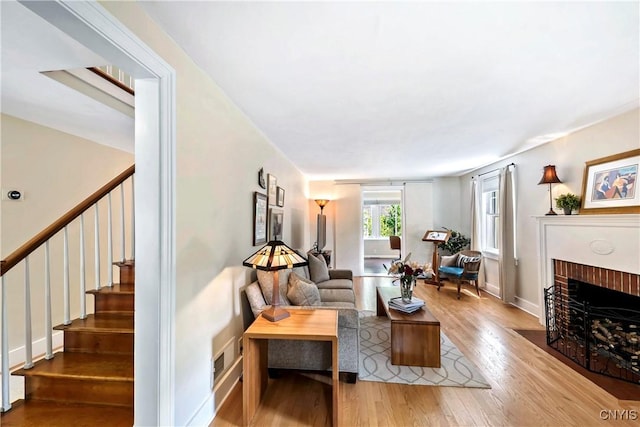 6 Orchard Rd, Skaneateles, NY 13152 - living area featuring stairway, wood finished floors, and a fireplace