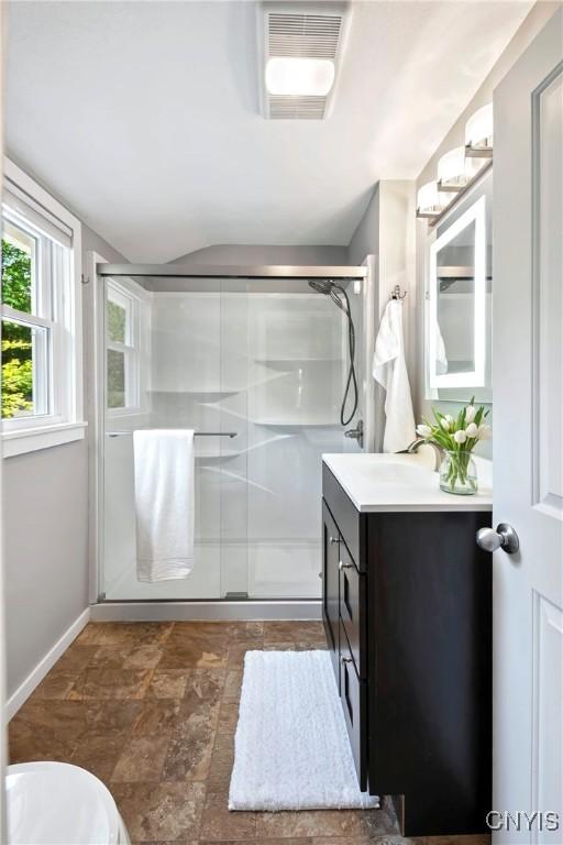 6 Orchard Rd, Skaneateles, NY 13152 - bathroom with a stall shower, vanity, and stone finish flooring