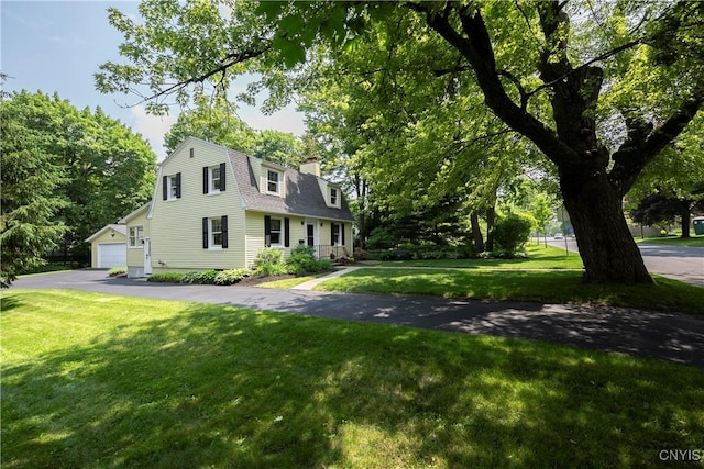 6 Orchard Rd, Skaneateles, NY 13152 - colonial inspired home with a front yard, a gambrel roof, a chimney, a shingled roof, and a garage