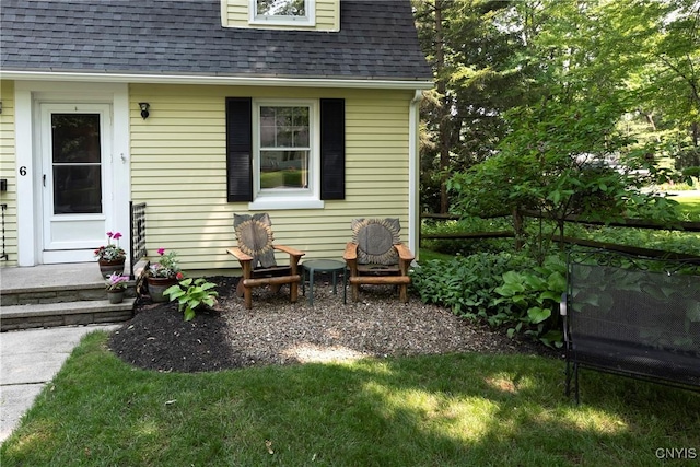 6 Orchard Rd, Skaneateles, NY 13152 - property entrance with roof with shingles and a lawn