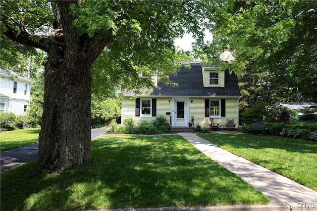 6 Orchard Rd, Skaneateles, NY 13152 - view of front facade with a front yard, a chimney, and a shingled roof