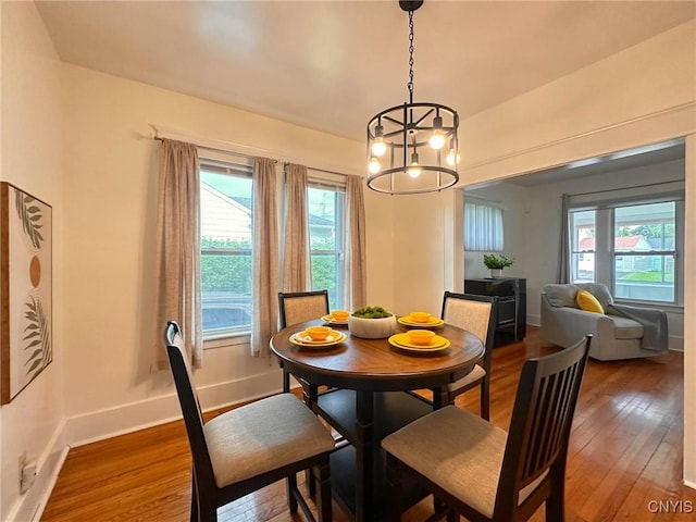 2132 Sinclair Ave, Whitestown, NY 13502 - dining room with wood-type flooring, a chandelier, and healthy amount of natural light