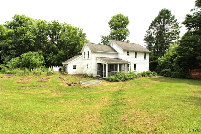 1500 Kimber Rd, Dewitt, NY 13078 - back of house with a vegetable garden, a sunroom, a yard, and roof with shingles