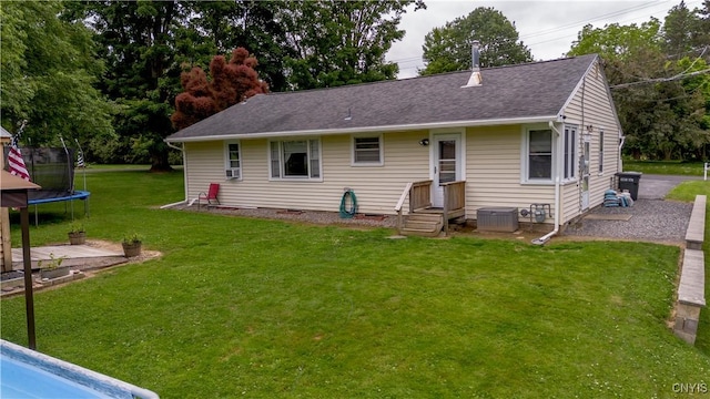 7 Bakeman St, Fulton, NY 13069 - rear view of property with a trampoline, a yard, and roof with shingles