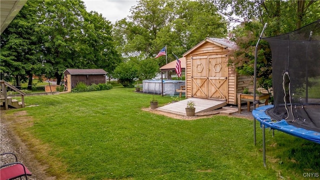 7 Bakeman St, Fulton, NY 13069 - view of green lawn with a trampoline, a storage unit, and an outdoor pool