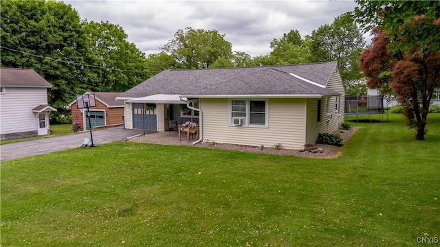 7 Bakeman St, Fulton, NY 13069 - bungalow featuring a trampoline, an outbuilding, driveway, a garage, and a front yard