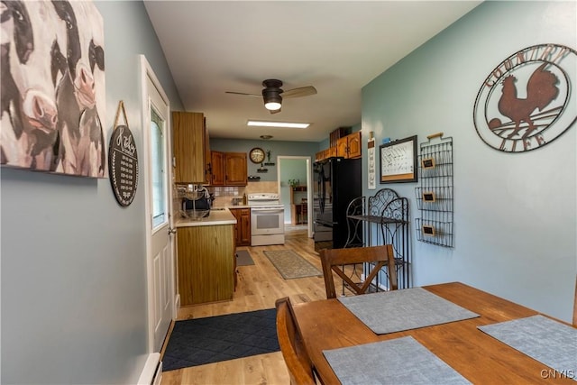 7 Bakeman St, Fulton, NY 13069 - dining room with light wood-type flooring and a ceiling fan
