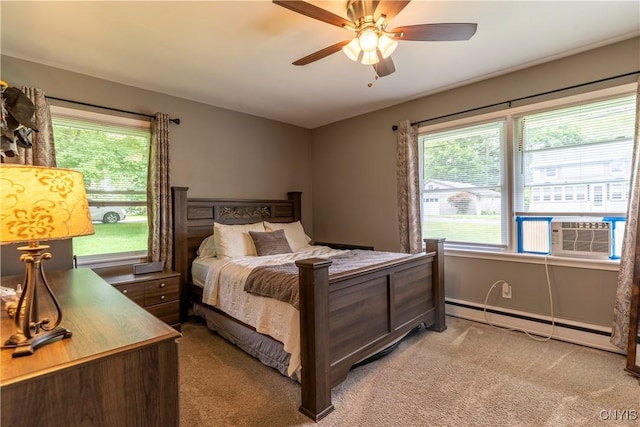 7 Bakeman St, Fulton, NY 13069 - bedroom featuring a baseboard heating unit, light colored carpet, and multiple windows