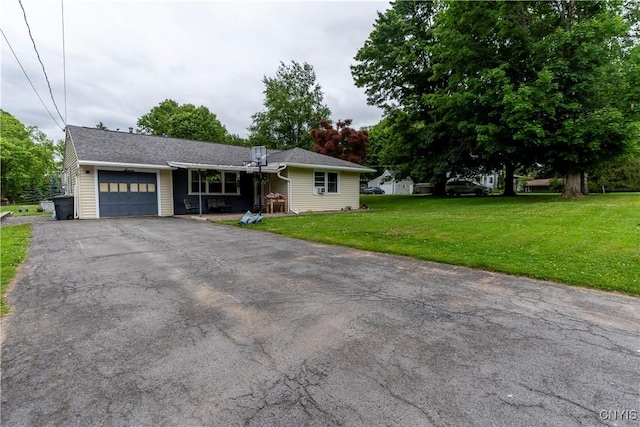 7 Bakeman St, Fulton, NY 13069 - view of front of home featuring an attached garage, asphalt driveway, and a front lawn