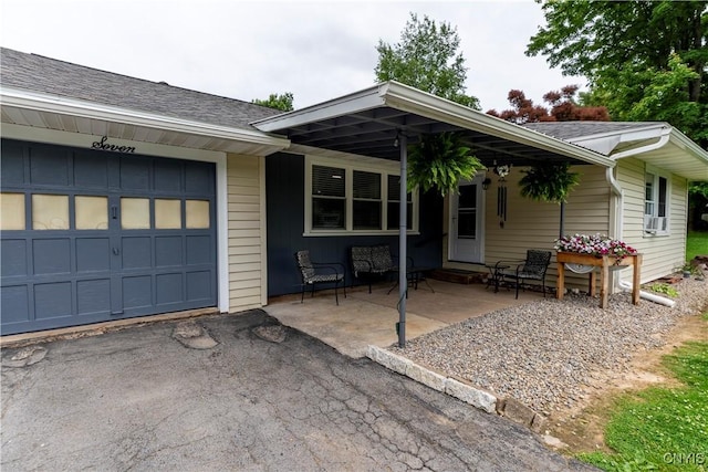 7 Bakeman St, Fulton, NY 13069 - view of front of house featuring an attached garage, a shingled roof, driveway, and cooling unit