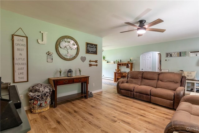 7 Bakeman St, Fulton, NY 13069 - living area with arched walkways, light wood-type flooring, a ceiling fan, and baseboard heating