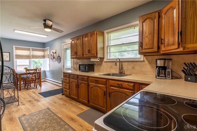7 Bakeman St, Fulton, NY 13069 - kitchen featuring black microwave, stove, brown cabinetry, and light countertops