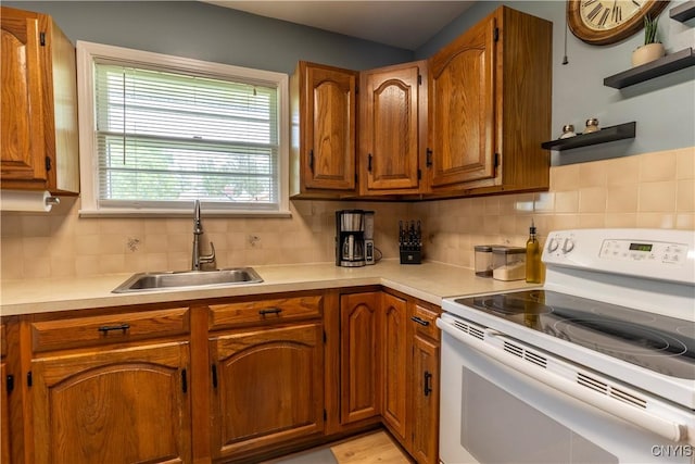 7 Bakeman St, Fulton, NY 13069 - kitchen featuring white electric stove, brown cabinets, and light countertops