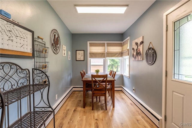 7 Bakeman St, Fulton, NY 13069 - dining room with a baseboard heating unit, light wood-type flooring, and healthy amount of natural light