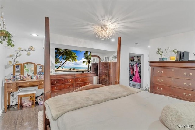84 Kurtz Ave, Lancaster, NY 14086 - bedroom featuring wood finished floors, a walk in closet, a closet, and recessed lighting