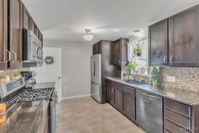 84 Kurtz Ave, Lancaster, NY 14086 - kitchen featuring stainless steel appliances, backsplash, dark stone counters, and dark brown cabinets