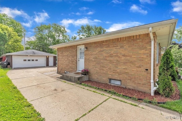 84 Kurtz Ave, Lancaster, NY 14086 - view of home's exterior featuring a detached garage, brick siding, and an outdoor structure