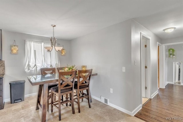 84 Kurtz Ave, Lancaster, NY 14086 - dining area featuring a chandelier and baseboards